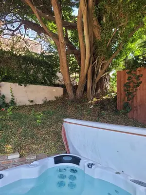 a bath tub in a yard with a tree at Westside Retreat w Yard, Grill, Hot Tub, Near Sofi Stadium, LAX, and the Beach in Los Angeles