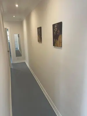 a hallway with three pictures on the wall at Hancock weho in Los Angeles