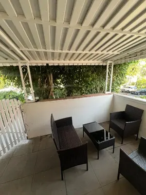 a patio with chairs and tables under a wooden ceiling at Hancock weho in Los Angeles