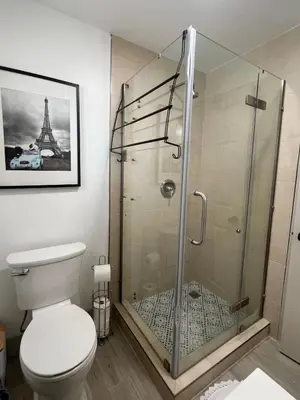 a bathroom with a glass shower with a toilet at Two Bedrooms Back House in Los Angeles in Los Angeles