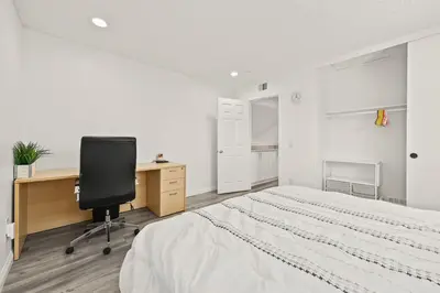a bedroom with a bed and a desk and a chair at Newly Remodel Luxury Home with Hotel-Like Amenity in Rowland