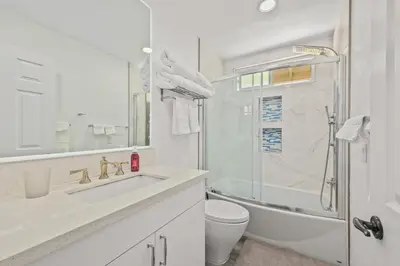 a white bathroom with a sink and a toilet at Newly Remodel Luxury Home with Hotel-Like Amenity in Rowland