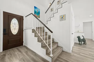 a staircase in a home with a dog in theoyer at Newly Remodel Luxury Home with Hotel-Like Amenity in Rowland