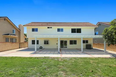 a large white house with a large driveway at Newly Remodel Luxury Home with Hotel-Like Amenity in Rowland