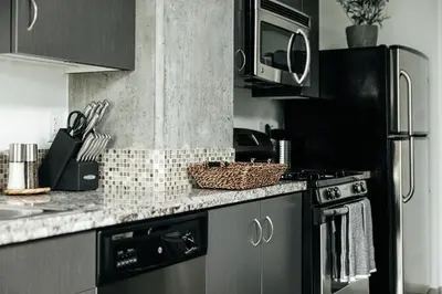 a kitchen with a stove and a microwave at Hollywood Designer Apartment in Los Angeles