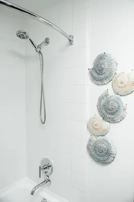 a bathroom with a shower with plates on the wall at Hollywood Designer Apartment in Los Angeles