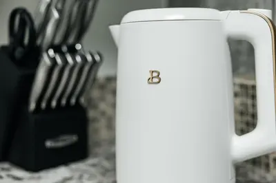 a white jug sitting on a counter next to some utensils at Hollywood Designer Apartment in Los Angeles