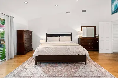 a bedroom with a bed and two dressers and a mirror at Luxury 4BD and 3BA in Topanga Oasis with Pool, Spa and Cabana in Glenview