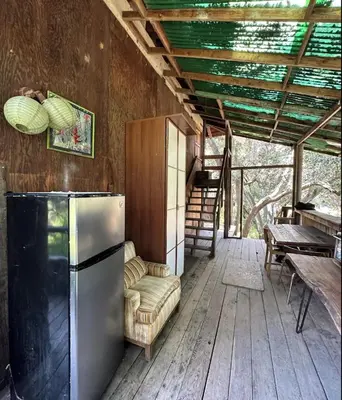 a kitchen with a refrigerator and a chair in a room at Japanese Tea House with Private Mountain Trails and Creek in Topanga Park
