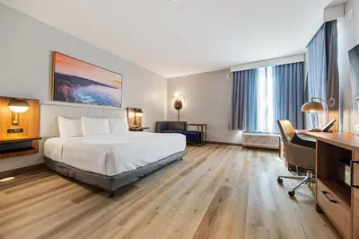 a hotel room with a bed and a desk at La Quinta Inn & Suites by Wyndham La Habra in La Habra