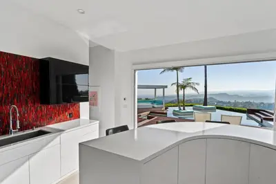 a white kitchen with a view of the ocean at Crest Estate by Stay Awhile Villas in Los Angeles
