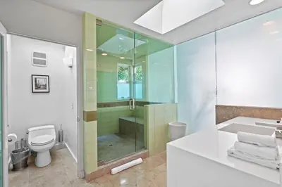 a bathroom with a shower and a toilet and a sink at Crest Estate by Stay Awhile Villas in Los Angeles
