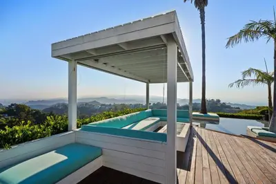 a wooden deck with a pergola and a swimming pool at Crest Estate by Stay Awhile Villas in Los Angeles