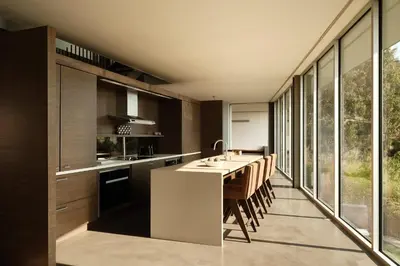 a kitchen with a long table and some windows at Eterne by Stay Awhile Villas in Los Angeles