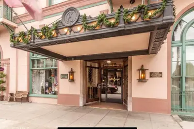 a store front with a balcony with plants on it at Chambre de Bonne in Downtown Long Beach in Long Beach