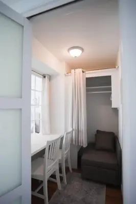 a small room with a table and chairs and a window at Chambre de Bonne in Downtown Long Beach in Long Beach