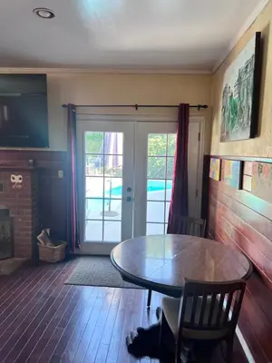 a dining room with a table and a sliding glass door at Cozy Room In Downey in Downey