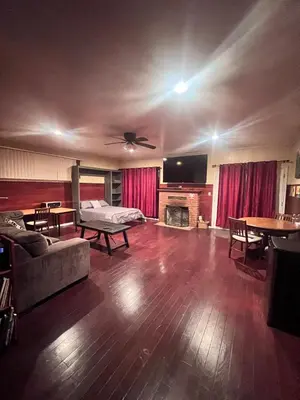 a living room with a couch and a fireplace at Cozy Room In Downey in Downey