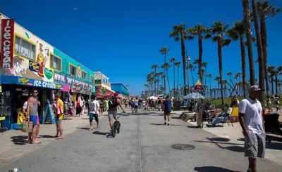 a group of people walking down a street with palm trees at Sunny 1 Bedroom in the Heart of Venice Beach - #3 in Los Angeles