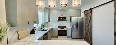 a kitchen with a stainless steel refrigerator and cabinets at Southwest Stay in Los Angeles