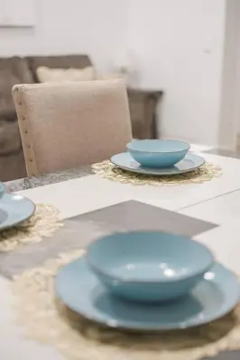 two blue bowls sitting on plates on a table at 2 TVs - Vaulted Ceiling - Private Kitchen & Entrance in Walnut