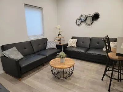 a living room with a black couch and a table at Prime LA 2 bedroom & 3 bath home Beverly Hills adj in Los Angeles