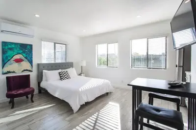a white bedroom with a bed and a desk at Sunny Studio in the Heart of Venice Beach - #5 in Los Angeles