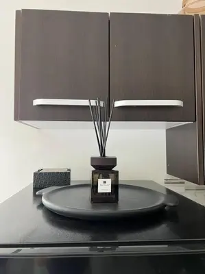a black table with a vase on top of it at Marilyn Studio Apartment in Koreatown in Los Angeles