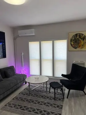 a living room with a couch and chairs and a table at Marilyn Studio Apartment in Koreatown in Los Angeles