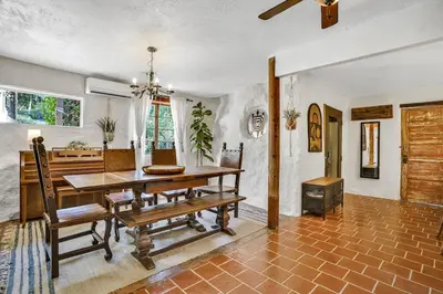 a dining room with a wooden table and chairs at Private Romantic Escape, Hidden Gem w Hot Tub in Chatsworth Lake Manor