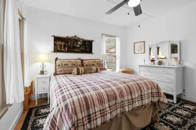 a bedroom with a bed and a ceiling fan at Mountain Cottage - Hot Tub! Walk to Lake and National Forest Hiking Trails in Big Bear Lake