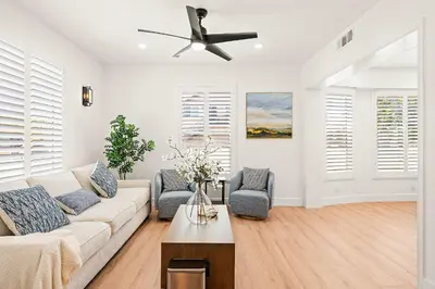 a living room with a couch and a ceiling fan at Cozy Retreat Near Downtown - Perfect for Families in Long Beach