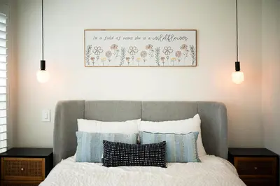 a bedroom with a bed with a picture on the wall at Cozy Retreat Near Downtown - Perfect for Families in Long Beach