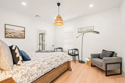 a bedroom with a bed and a chair at Cozy Retreat Near Downtown - Perfect for Families in Long Beach