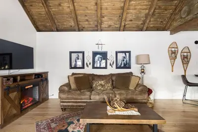 a living room with a couch and a table at Dream Catcher Retreat in Big Bear Lake