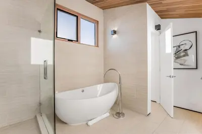 a bath tub in a bathroom with a window at Cedar Loft Villa in Los Angeles