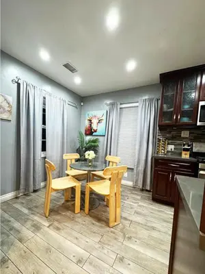 a dining room with a table and two chairs and a kitchen at Cozy 2BR Getaway with Pool, Close to SoFi - MKMD1 in Los Angeles