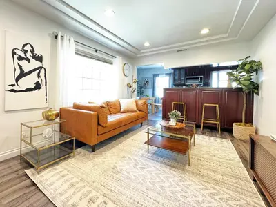 a living room with a couch and a table at Cozy 2BR Getaway with Pool, Close to SoFi - MKMD1 in Los Angeles