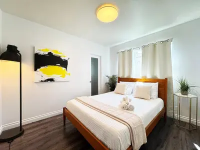 a bedroom with a bed with a teddy bear on it at Cozy 2BR Getaway with Pool, Close to SoFi - MKMD1 in Los Angeles