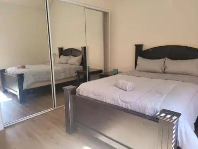 a bedroom with a bed and a mirror at 3BR & Loft near Palmdale Hospital in Palmdale