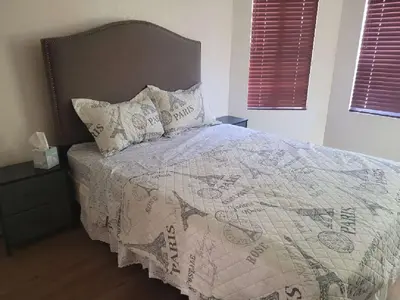 a bedroom with a bed with a blanket and pillows at 3BR & Loft near Palmdale Hospital in Palmdale