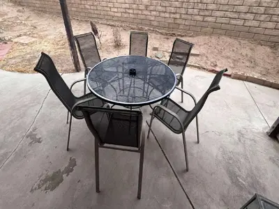 a glass table with four chairs around it at 3BR & Loft near Palmdale Hospital- Shared Hm in Palmdale