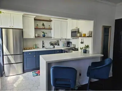a kitchen with blue cabinets and blue chairs at Luxe Suite Convention Center Partial Ocean View with Free Parking in Long Beach