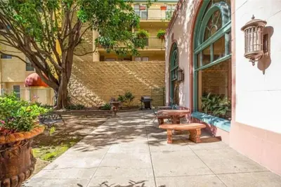 a patio with a bench and a building at Luxe Suite Convention Center Partial Ocean View with Free Parking in Long Beach