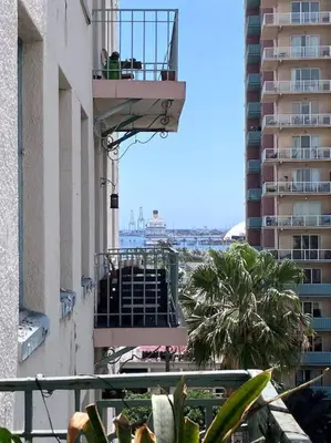 a balcony of a building with palm trees and buildings at Luxe Suite Convention Center Partial Ocean View with Free Parking in Long Beach