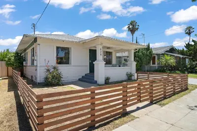 a house with a wooden fence in front of it at Walk to Beach and Restaurants - Easy Parking in Long Beach