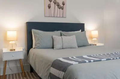 a bedroom with a large bed with two lamps at Walk to Beach and Restaurants - Easy Parking in Long Beach