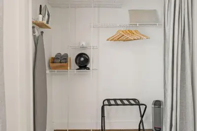 a room with a glass wall with shelves and a chair at Walk to Beach and Restaurants - Easy Parking in Long Beach