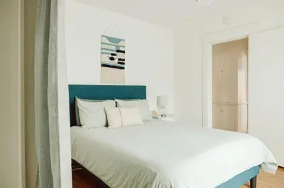 a bedroom with a large white bed with white pillows at Walk to Beach and Restaurants - Easy Parking in Long Beach