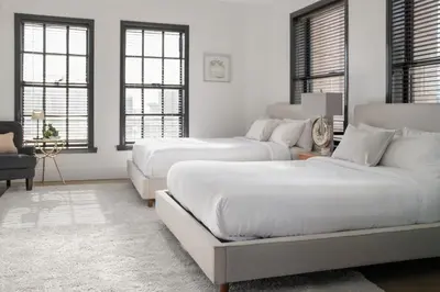 two beds in a white room with windows at Gorgeous Apartment 2-bedroom 2-bathroom in Los Angeles